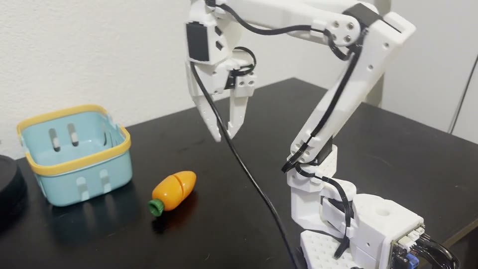 SO-101 robot, carrot, and target container during a closed-loop rollout.